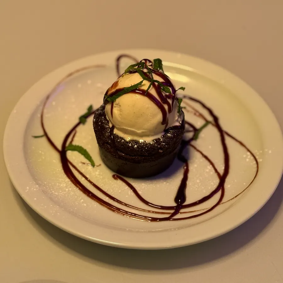 Chocolate pudding with vanilla ice cream and chocolate sauce