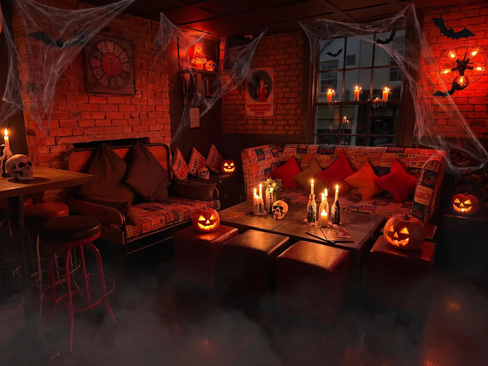 Brick-walled lounge at Fizzy Moon with Halloween candles, skulls and pumpkins